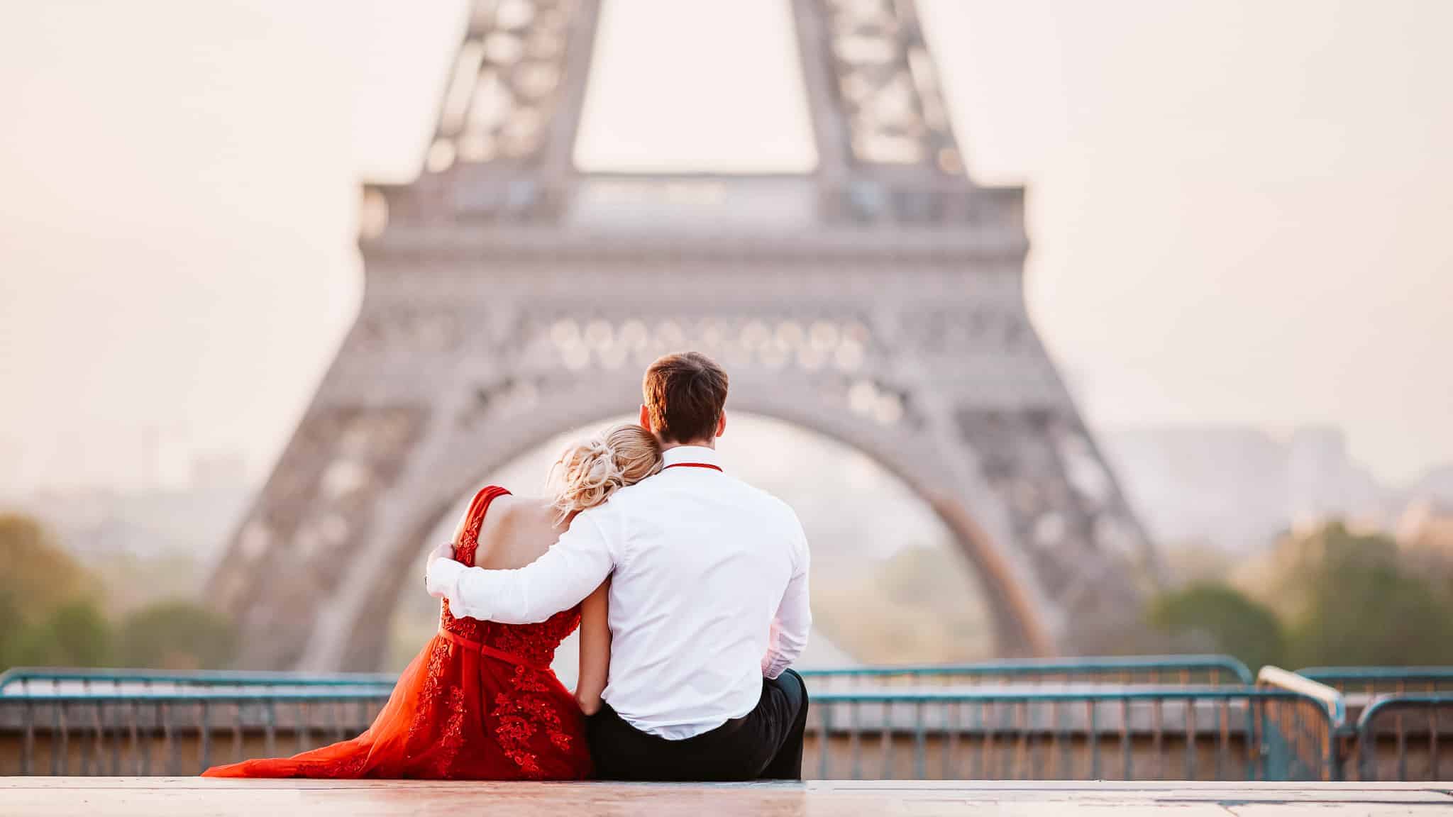 Couple near the Eiffel tower in Paris, France 12 Dreamy European Destinations Made for a Romantic Getaway