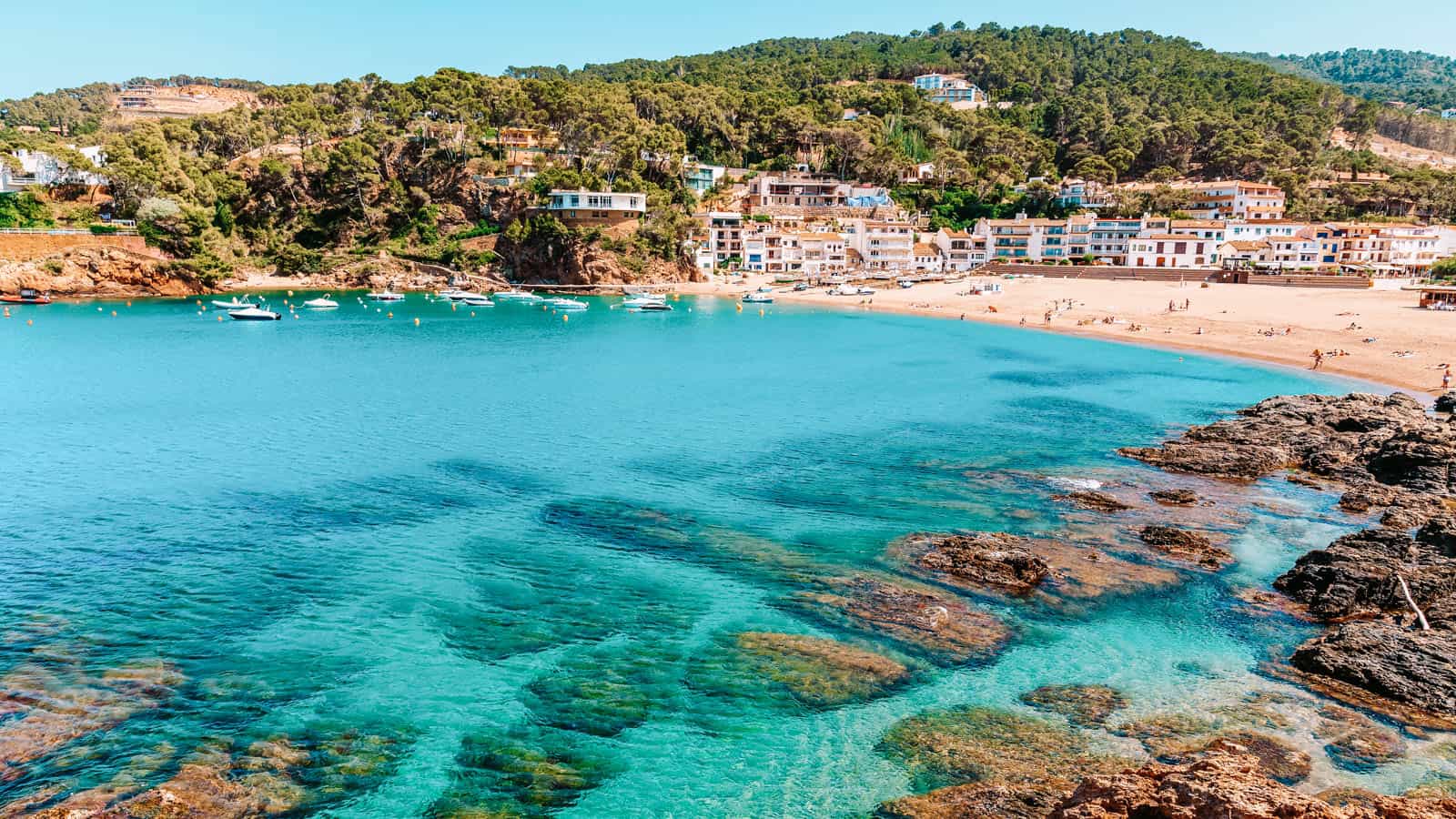 View of bay with azure sea water in beautiful Sa Riera village, 12 Hidden Beaches in Europe to Avoid the Crowds