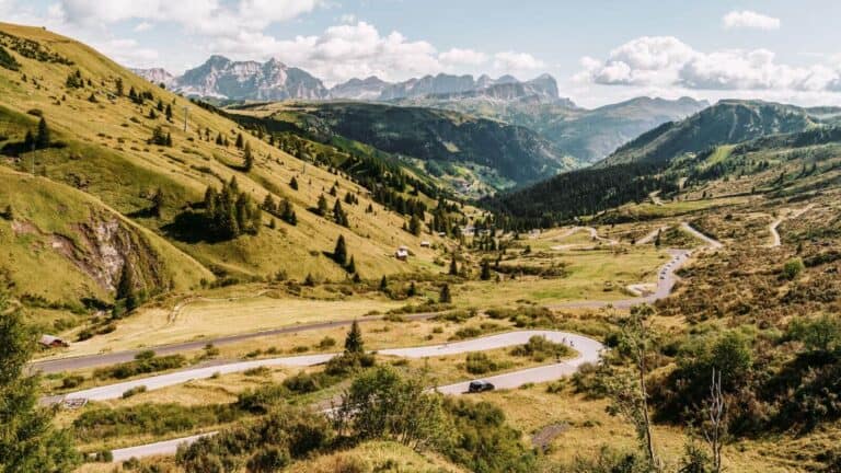 Scenic view of The Great Dolomite Road with towering jagged mountain peaks and winding alpine road