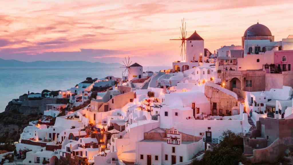 Tourist Traps To Avoid in the Greek Islands Taking Photos of Santorini at Sunset